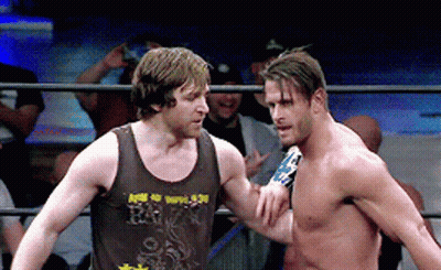 Two Men In A Wrestling Ring One Of Whom Is Wearing A Tank Top That Says R.i.p. GIF
