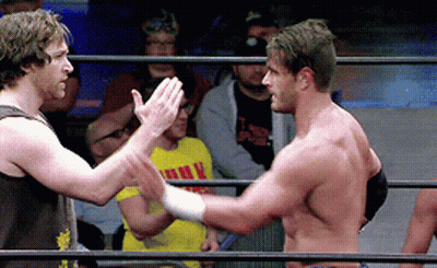 Two Men In A Wrestling Ring One Of Whom Is Wearing A Yellow Shirt That Says ' I Love You ' On It GIF