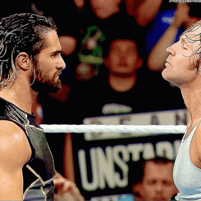 Two Men In A Wrestling Ring With A Sign That Says Unsuitable In The Background GIF