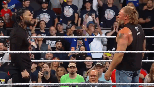 Two Men In A Wrestling Ring With One Wearing A Shirt That Says ' We 'Re Not Friends ' GIF