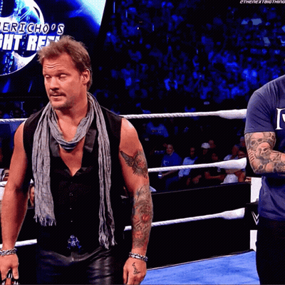 Two Men In A Wrestling Ring With The Words Jericho 'S Fight Reel On The Screen Behind Them GIF