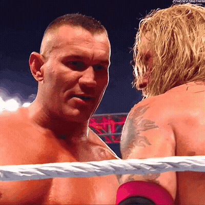 Two Men In A Wrestling Ring With The Words " The Next Thing " On The Bottom Right GIF