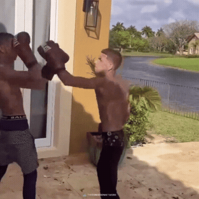 Two Men In Bale Underwear Boxing Outside GIF