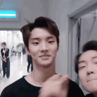 Two Men In Black Shirts Standing Together GIF