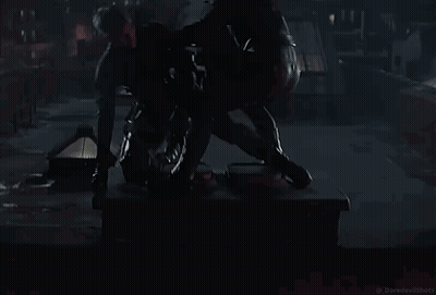 Two Men In Black Suits In Dark Room GIF
