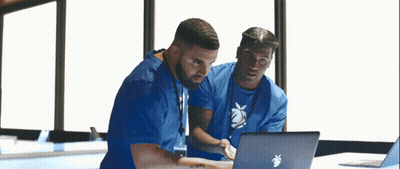 Two Men In Blue Scrubs Looking At Apple Laptop GIF