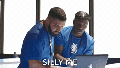 Two Men In Blue Scrubs Looking At Laptop GIF