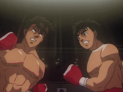 Two Men In Boxing Gloves Are Standing In A Ring GIF