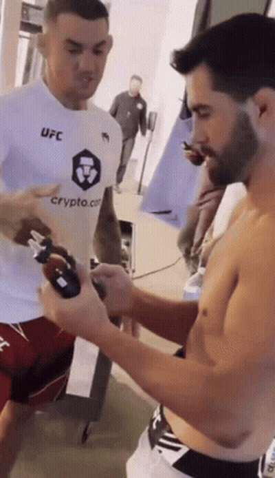 Two Men In Boxing Ring With Guaranteed Pain Sign GIF