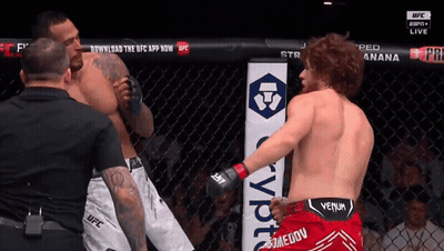 Two Men In Cage With Red Venum Shorts GIF