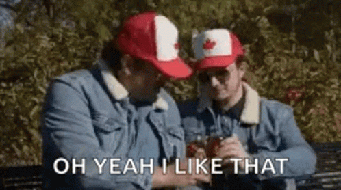 Two Men In Canadian Hats Sitting On Bench Holding Drinks GIF