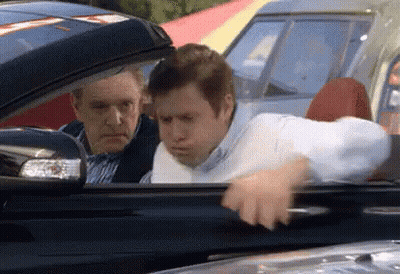 Two Men In Car One Looking Out Window GIF