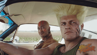 Two Men In Car With Street Fighter On Chests GIF