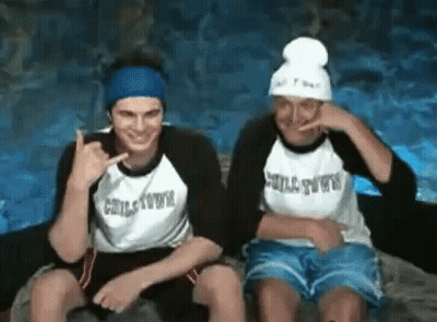 Two Men In Chilltown Shirts Sitting Together GIF