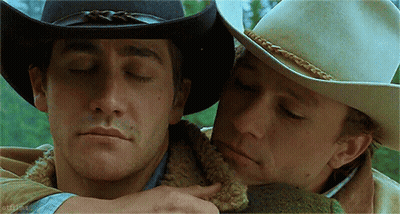 Two Men In Cowboy Hats Hugging GIF
