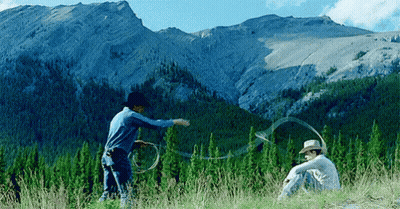 Two Men In Cowboy Hats Playing With Lasso GIF