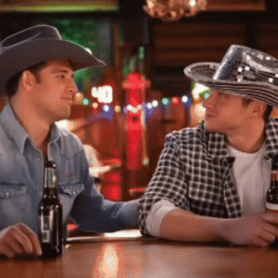 Two Men In Cowboy Hats Sitting At Bar GIF