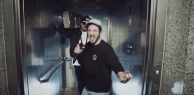 Two Men In Elevator One In Black Mercedes Shirt GIF