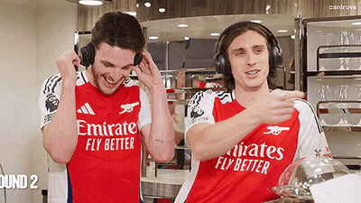 Two Men In Emirates Fly Better Shirts Laughing And Listening To Music GIF