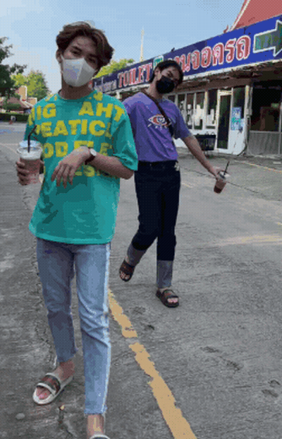 Two Men In Face Masks Walking Past Toilet Sign GIF