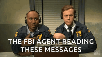 Two Men In Fbi Uniforms Are Reading Messages GIF
