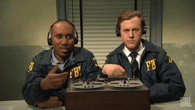 Two Men In Fbi Uniforms Sit At A Desk With A Tape Recorder GIF