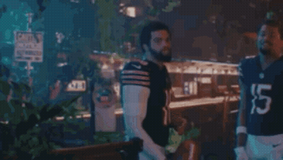 Two Men In Football Uniforms Standing GIF