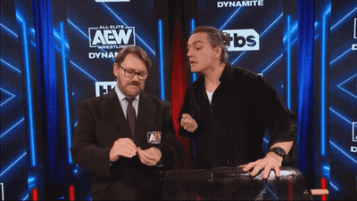 Two Men In Front Of AEW Sign GIF