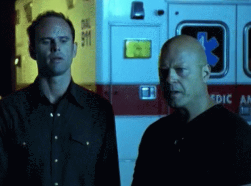 Two Men In Front Of Ambulance GIF