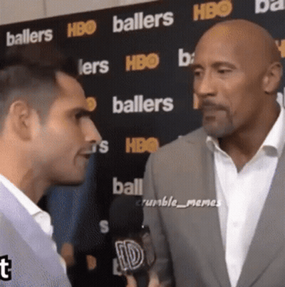 Two Men In Front Of Baller Wall GIF