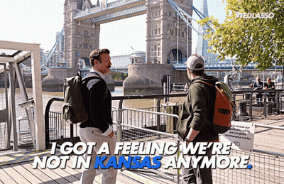 Two Men In Front Of Bridge Saying I Got A Feeling We're Not In Kansas Anymore GIF