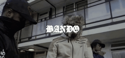Two Men In Front Of Building With Bando GIF