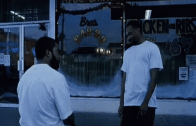 Two Men In Front Of Chicken Shop GIF