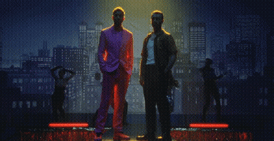 Two Men In Front Of City Skyline GIF