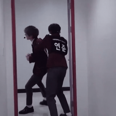 Two Men In Front Of Mirror One Wearing Tomorrow Shirt GIF