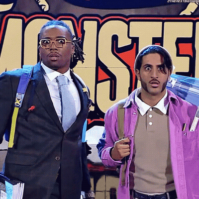 Two Men In Front Of Monsters Sign GIF