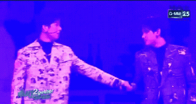 Two Men In Front Of Purple Background Saying GMM 25 GIF