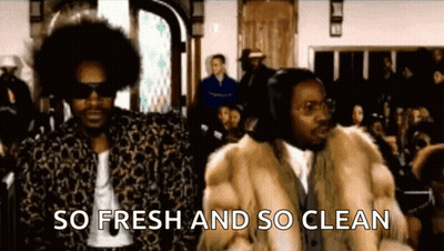 Two Men In Fur Coats Standing Before Crowd GIF