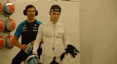Two Men In Garage One Wearing Headphones GIF