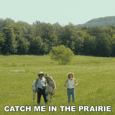 Two Men In Grassy Field Catch Me In The Prairie GIF