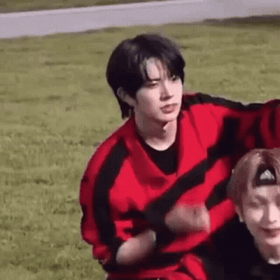Two Men in Grassy Field Man in Red and Black Sweater