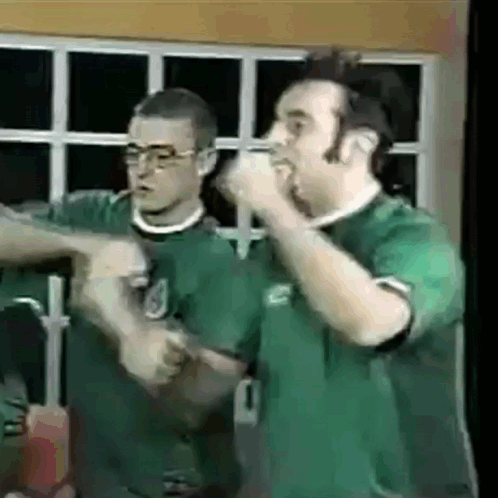 Two Men In Green Shirts One With Number 1 GIF