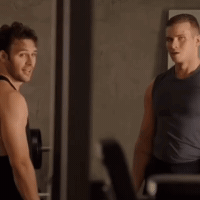Two Men In Gym One Touching Other's Neck GIF