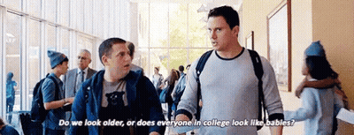 Two Men In Hallway Asking About College Looks GIF