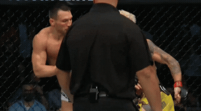 Two Men In Hallway One In Suit And Tie GIF