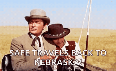 Two Men In Hats Sitting In Field Safe Travels Back To Nebraska GIF