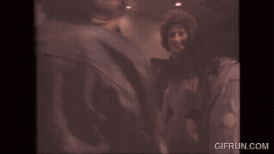 Two Men In Headphones High Fiving While Dancing GIF