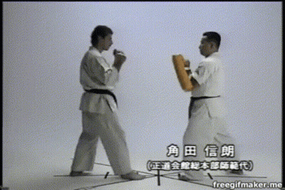 Two Men In Karate Uniforms Are Standing Next To Each Other And Their Names Are Written In Chinese GIF