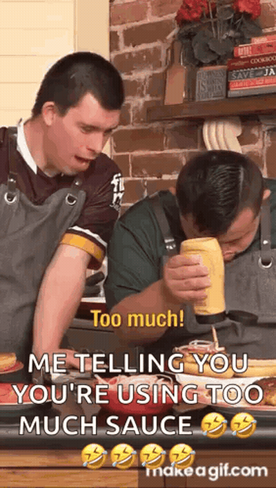 Two Men In Kitchen One Pouring Mustard On Food GIF