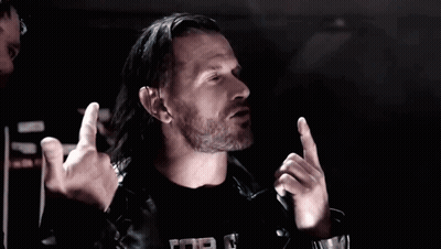 Two Men In Leather Jackets Are Giving The Middle Finger In A Dark Room GIF